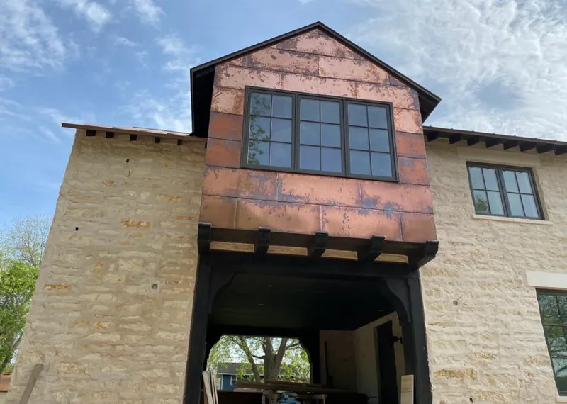 Copper metal panel facade on a stone building for Skylight Installation in Powdersville